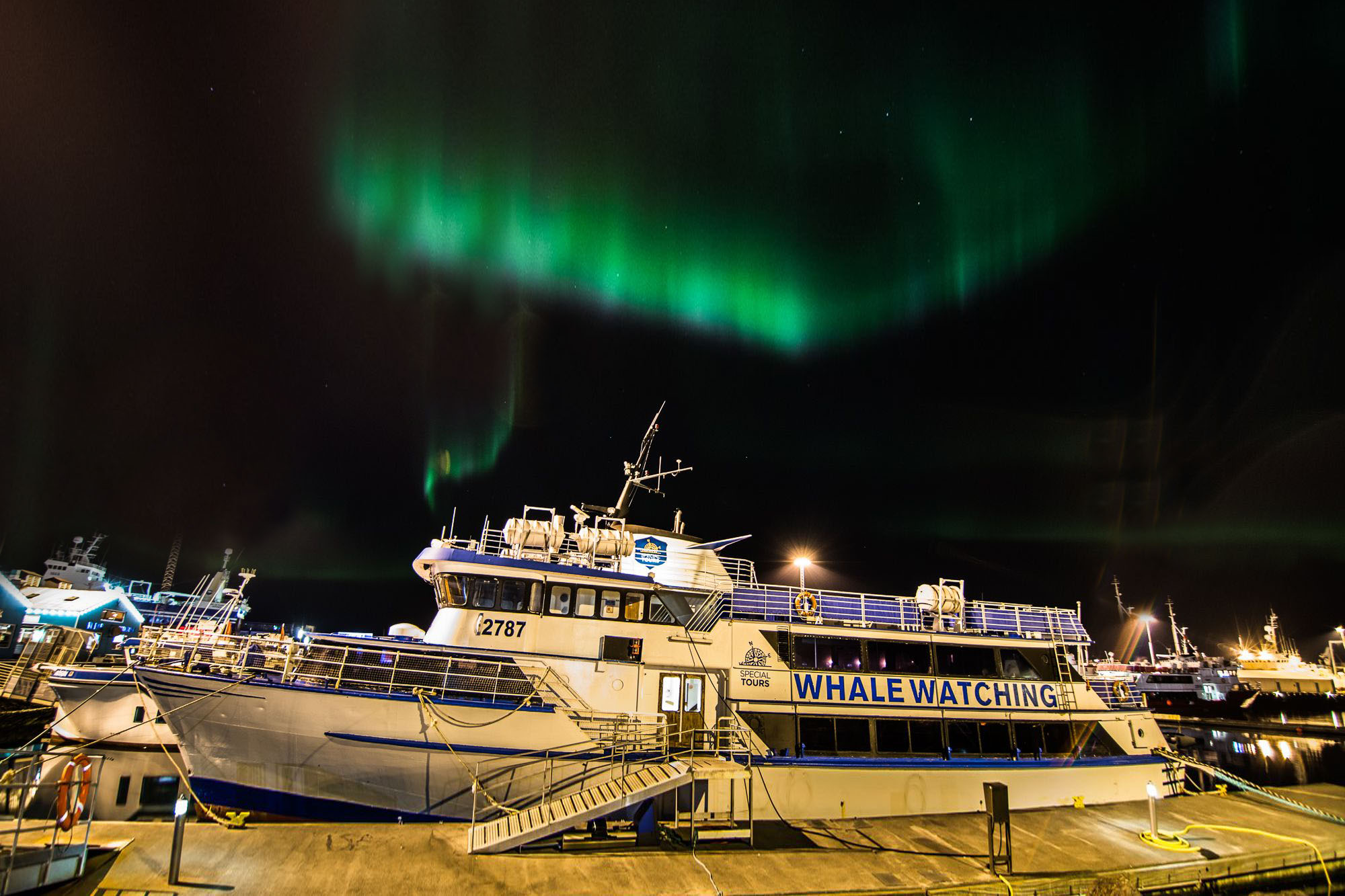 Northern Lights Evening Cruise with Special Tours Special Tours Northern Lights Cruise Ship Andrea in the harbour of Reykjavik with dancing Northern Lights