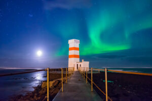 Northern Lights under a full moon in Iceland