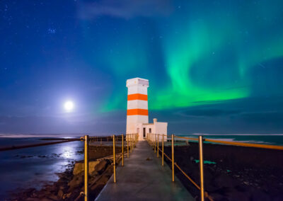 Northern Lights under a full moon in Iceland
