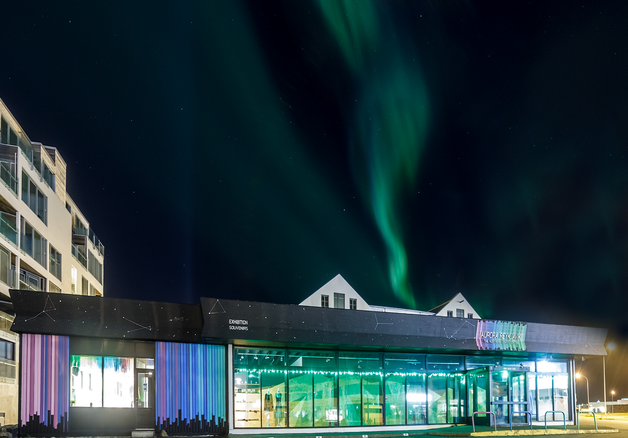 Northern lights over the northern lights center - Aurora Reykjavík