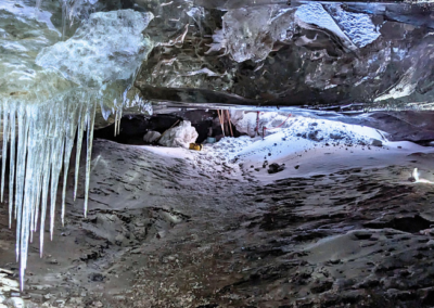 The inside of an ice cave on Langjökull glacier. Icicles and blue ice ceilings.