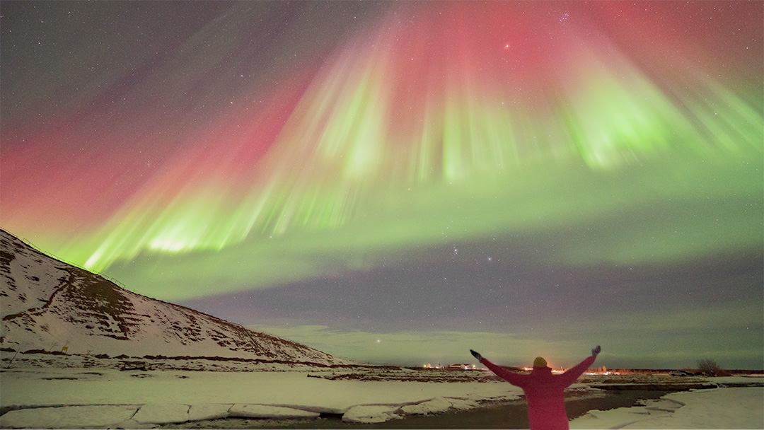 Red auroras at Skoógafoss, Iceland
