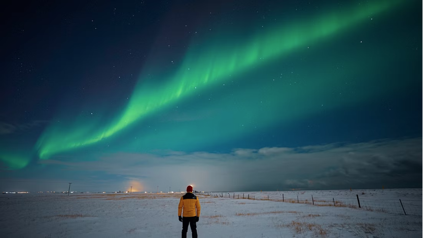 Tourist watching the northern lights in the country