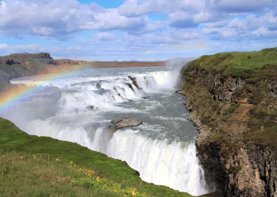 Aerial view of the Gullfoss waterfall with a rainbow over it