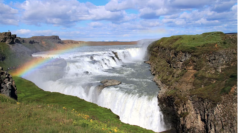Aerial view of the Gullfoss waterfall with a rainbow over it