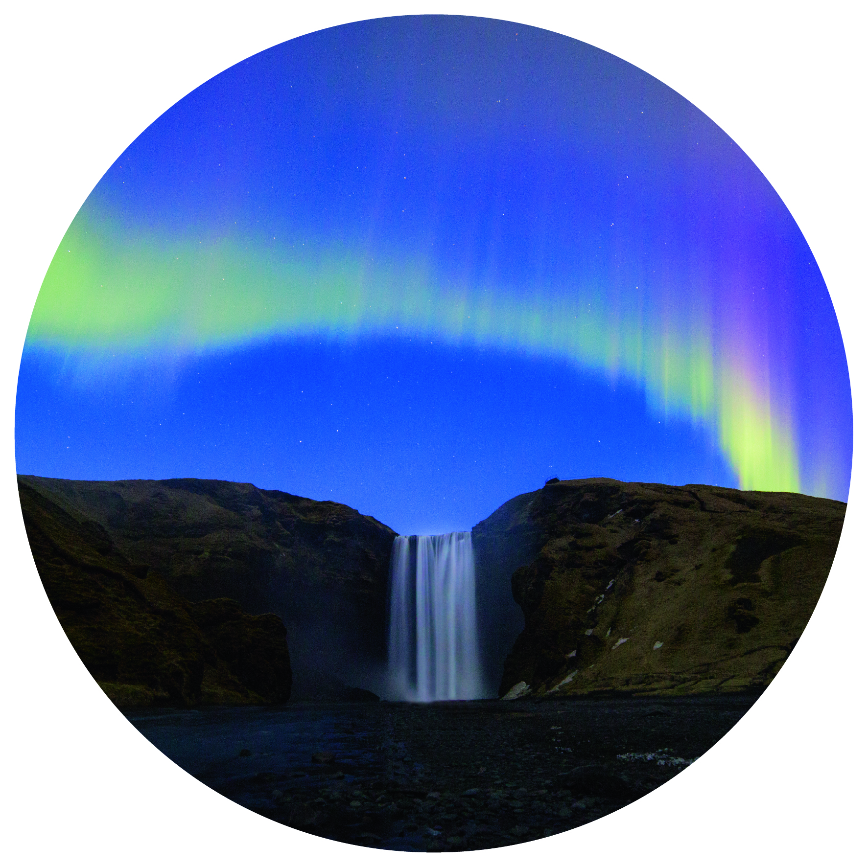 pink and green northern lights over a mountain, with Skogafoss waterfall flowing in the middle