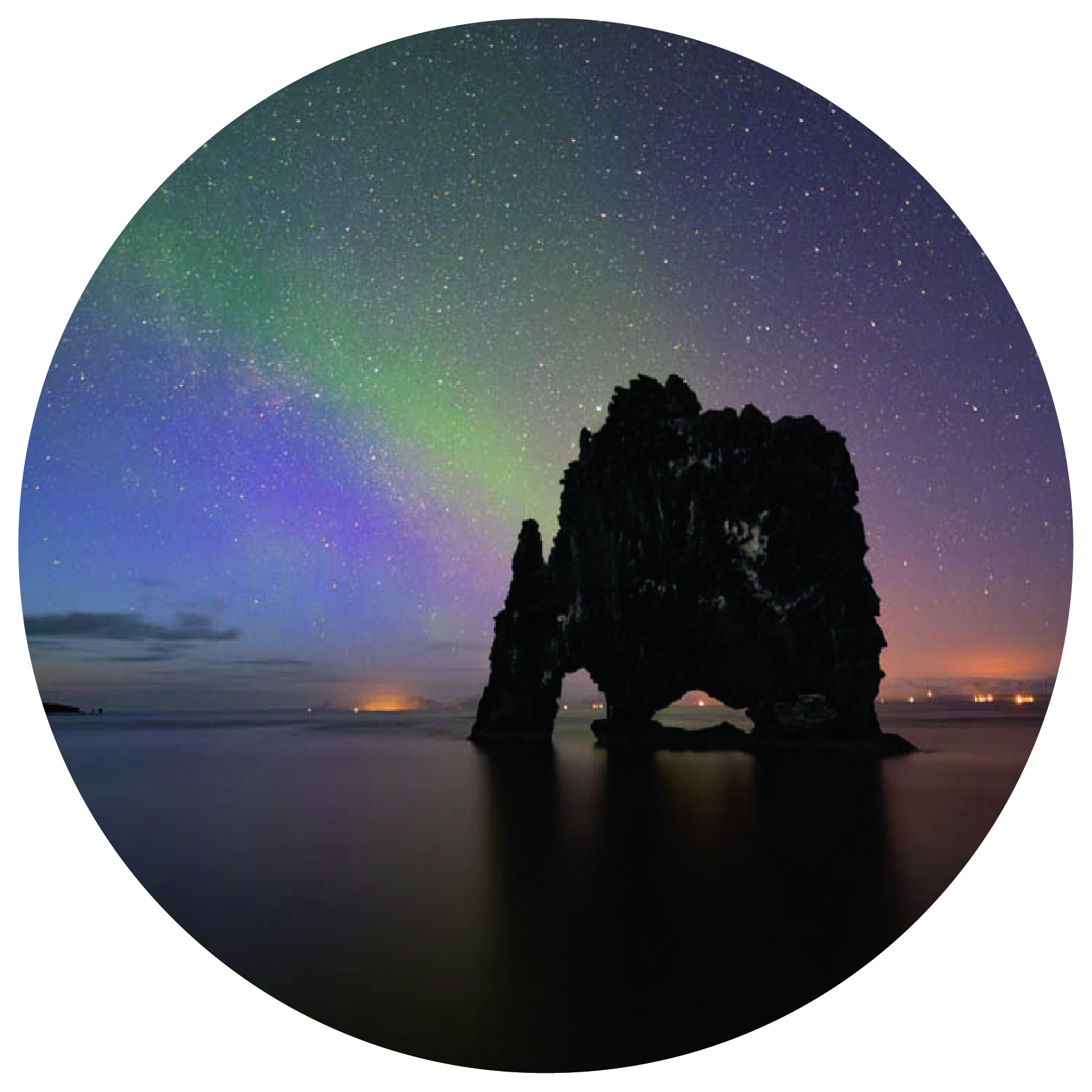 The elephant-shaped formation in the ocean against a backdrop of green and blue northern lights in the starry sky