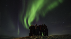 Travellers taking a picture under the northern lights