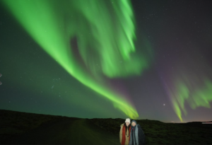 Couple posing under the northern lights