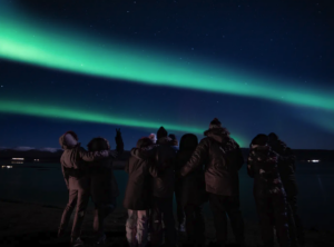 Travellers watching the northern lights