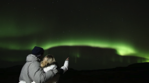 Travellers watching the northern lights