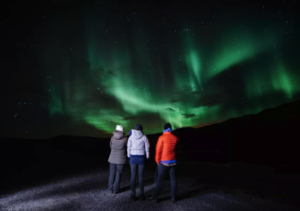 Travellers watching the northern lights