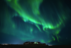 Northern lights over a farm house