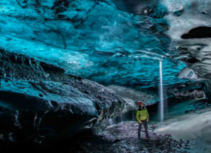 Traveller exploring a natural ice cave