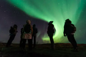 Travellers watching the northern lights