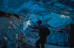 Visitors taking pictures inside a glacier