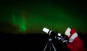 Visitor stargazing with a telescope