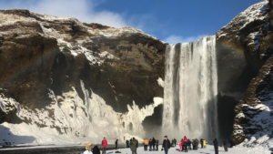 Skógafoss waterfall surrounded by snow