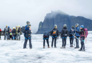 Travellers posing for a photo during a glacier hike