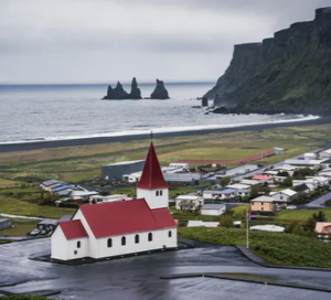 Panoramic view over the ocean and iconic cliffs from the Vík church