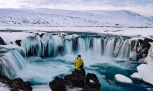 A traveller enjoying the winter view at Góðafoss
